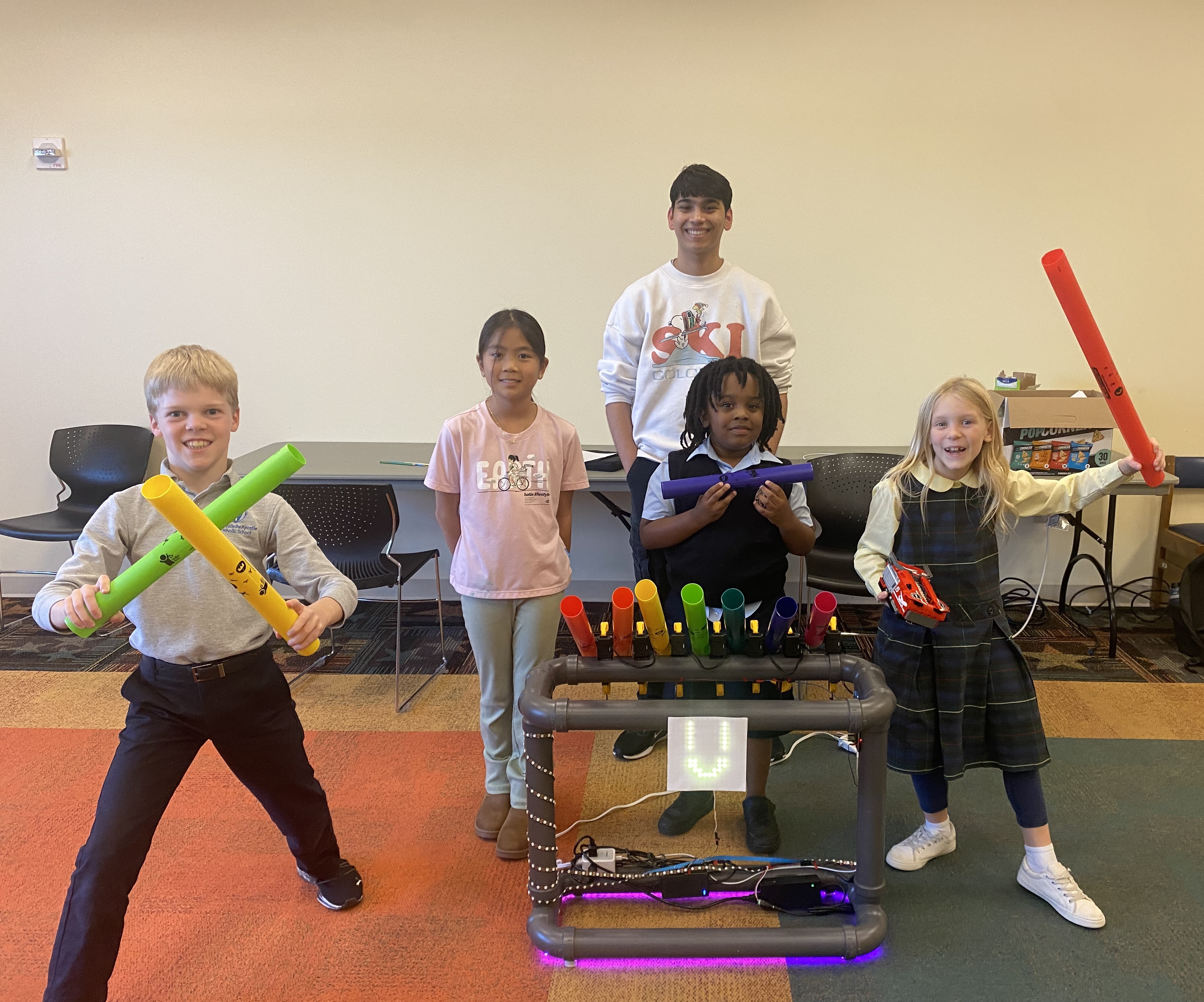 Students and BoomBot performing a simple song together using Boomwhackers